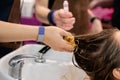 Woman hair stylist washing customers hair at hairdressing salon - close up Royalty Free Stock Photo