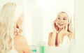 Woman in hairband touching her face at bathroom Royalty Free Stock Photo