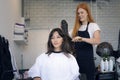 Woman hairdresser in beauty salon cut hair and hair design Royalty Free Stock Photo