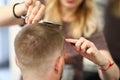 Woman hairdresser cuts man`s hair in a beauty salon Royalty Free Stock Photo
