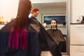 Woman hairdresser drying young woman customer hair in salon Royalty Free Stock Photo