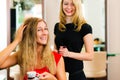 Woman at the hairdresser getting advise Royalty Free Stock Photo