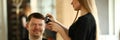 Woman Hairdresser Making Razor Haircut for Man Royalty Free Stock Photo