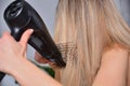 Radiant Beauty: Young Woman Perfects Her Hairstyle After a Refreshing Shower