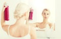 Woman with hairspray styling her hair at bathroom Royalty Free Stock Photo