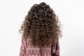 A woman with curly long dark hair, turned her back Royalty Free Stock Photo