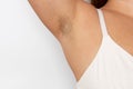 Woman with hairy underarms closeup, free copy space, white background. Raised arm with armpit hair. Female beauty trend Royalty Free Stock Photo