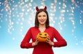 Woman in halloween costume of devil with pumpkin Royalty Free Stock Photo