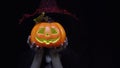 Woman in Halloween costume holding Halloween pumpkin or Jack O Lantern instead of head Royalty Free Stock Photo