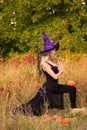 Woman in witch costume practicing yoga