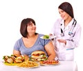 Woman with hamburger and doctor. Royalty Free Stock Photo