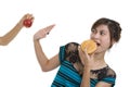 Woman with hamburger refusing an apple Royalty Free Stock Photo