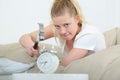 woman with hammer aiming at alarm clock Royalty Free Stock Photo