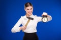 Woman with hammer and alarm clock Royalty Free Stock Photo