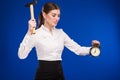 Woman with hammer and alarm clock Royalty Free Stock Photo