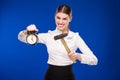 Woman with hammer and alarm clock Royalty Free Stock Photo