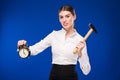 Woman with hammer and alarm clock Royalty Free Stock Photo