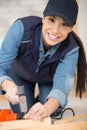 woman hammering nail into wood Royalty Free Stock Photo