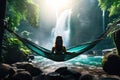 A woman on a hammock on beautiful waterfall background Royalty Free Stock Photo