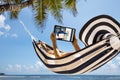 Woman In Hammock Looking At Home Security Camera Royalty Free Stock Photo