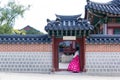 Woman in Hanbok dress with ancient Korean palace Royalty Free Stock Photo