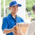 Woman hand accepting a delivery of boxes from deliveryman Royalty Free Stock Photo