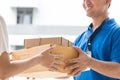 Woman hand accepting a delivery of boxes from deliveryman Royalty Free Stock Photo