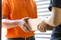 Woman hand accepting a delivery of boxes from deliveryman. Royalty Free Stock Photo