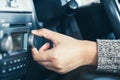 Woman hand adjusting the sound volume of car radio Royalty Free Stock Photo