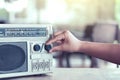 Woman hand adjusting the sound volume on retro radio cassette Royalty Free Stock Photo