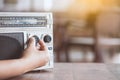 Woman hand adjusting the sound volume on retro radio cassette Royalty Free Stock Photo