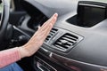 Woman hand on air conditioner ventilation grille in the car. Climate control panel Royalty Free Stock Photo