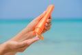 Woman hand apply sunscreen / sunblock on the beach Royalty Free Stock Photo