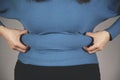 Woman hand belly fats