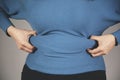 Woman hand belly fats