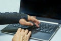 Woman hand in black orthosis is working on computer. A freelancer with one broken wrist typing on laptop computer on keyboard Royalty Free Stock Photo