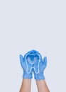 Woman hand in blue medical gloves holding silicone mouth guard with thin linear molar tooth, outline icon. Tooth symbol sign. Royalty Free Stock Photo
