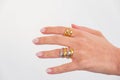 Woman hand with Bold Adjustable Golden and Silver Rings set against a white background