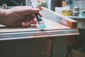 Woman hand with brush paint wooden desk with chalky paint