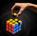 Woman hand builds cube rubik concept, collage