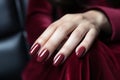 Woman hand with burgundy color nail polish on her fingernails. Burgundy nail manicure with gel polish at luxury beauty salon. Nail