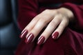 Woman hand with burgundy color nail polish on her fingernails. Burgundy nail manicure with gel polish at luxury beauty salon. Nail