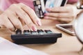 Woman hand calculating her expenses and debt from credit cards Royalty Free Stock Photo