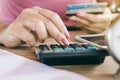 Woman hand calculating her expenses and debt from credit cards Royalty Free Stock Photo