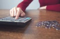 Woman hand calculator and coins