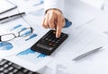 Woman hand with calculator and papers Royalty Free Stock Photo