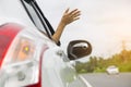 Woman hand at the car window on an empty country road. Royalty Free Stock Photo