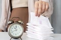 woman hand changing pads with an alarm clock on the table