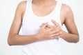 Woman hand checking lumps on her breast for signs of breast cancer on gray background. Healthcare concept. Royalty Free Stock Photo