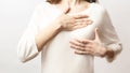 Woman hand checking lumps on her breast for signs of breast cancer on white background. Healthcare concept. Cancer self check; Royalty Free Stock Photo